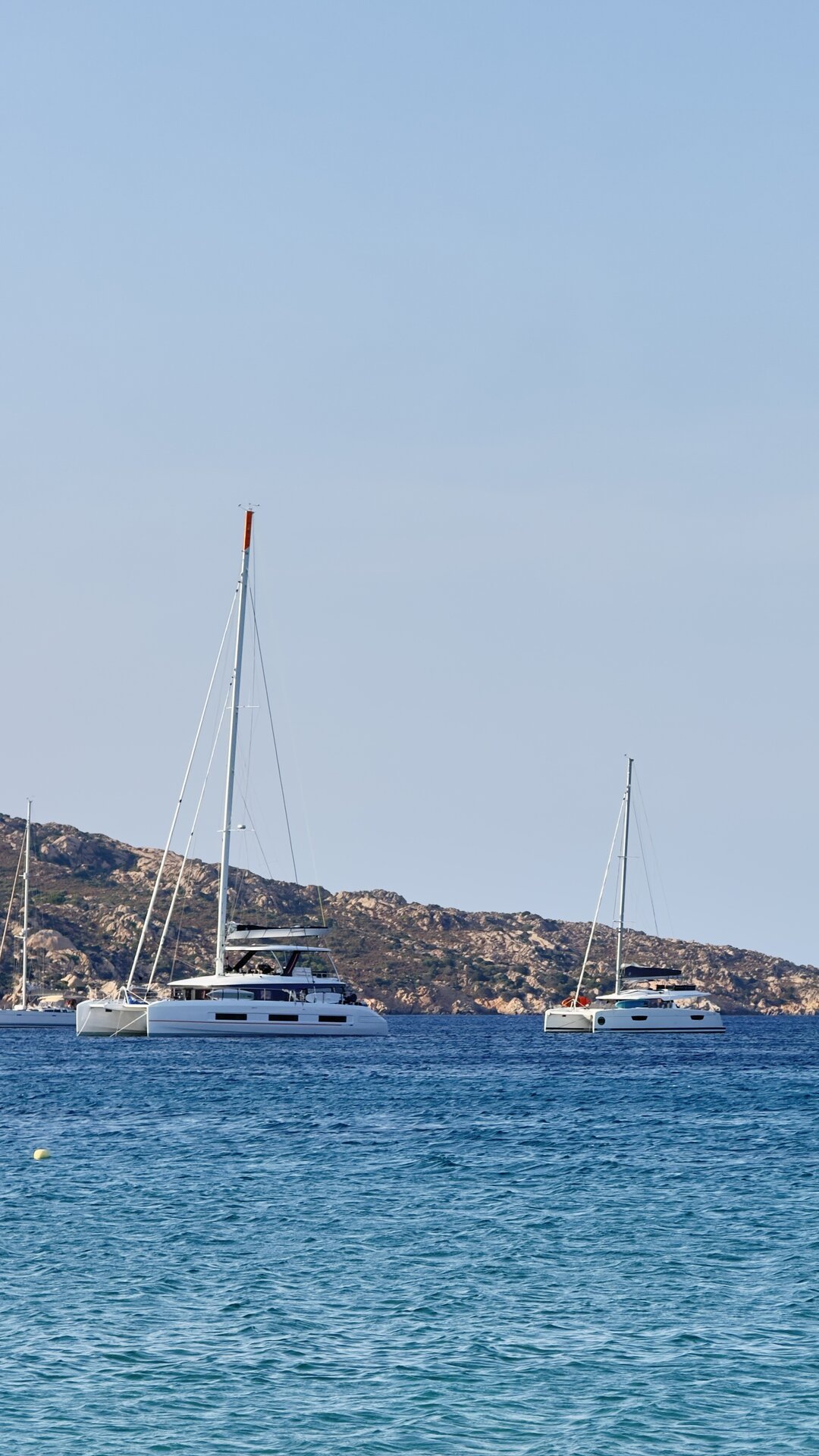 Catamarans at peaceful anchor in a quiet Baja California Sur cove — BAIA Atelier
