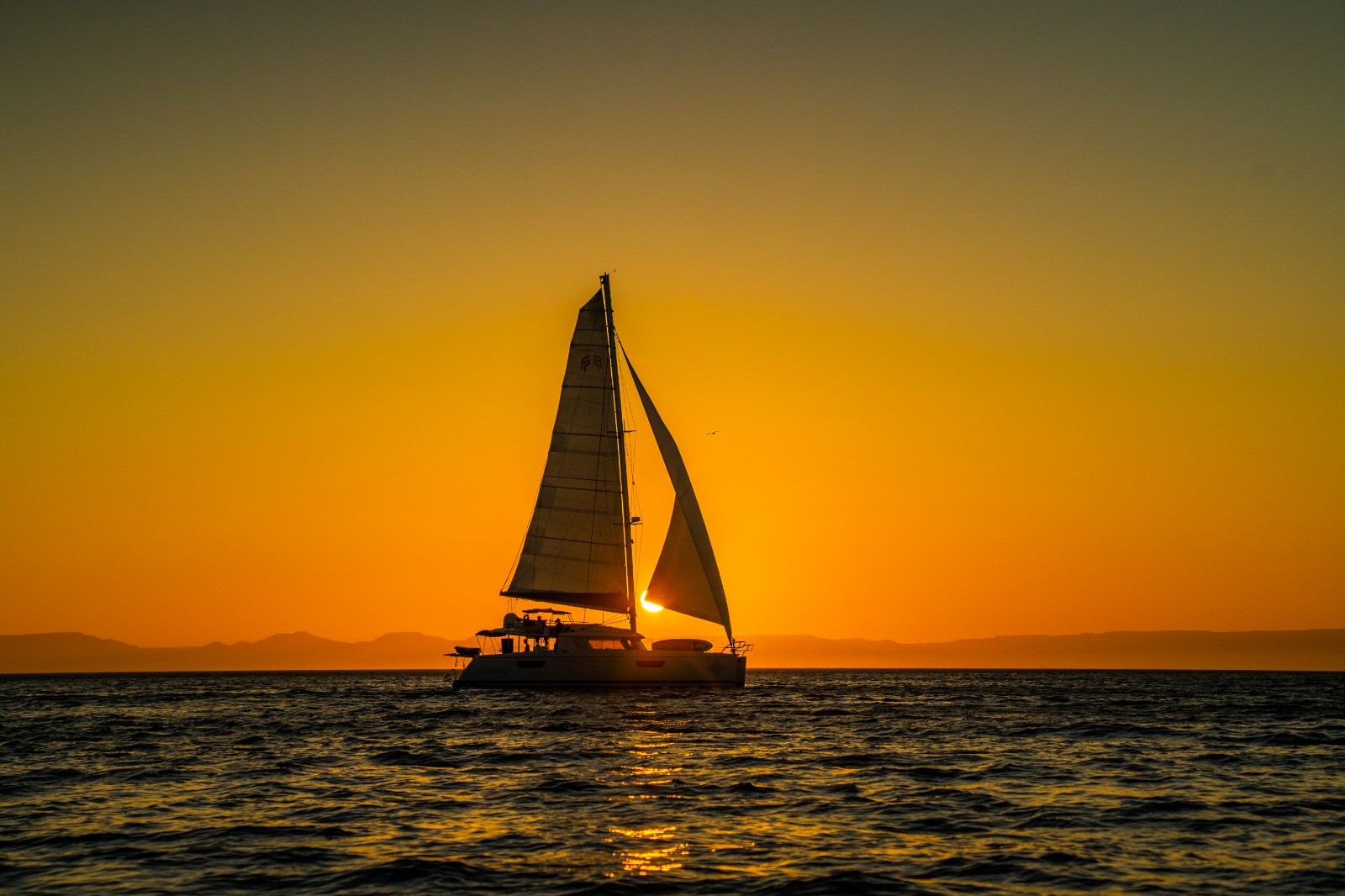 Luxury catamaran charter at golden hour on the Sea of Cortez near La Paz — BAIA Atelier