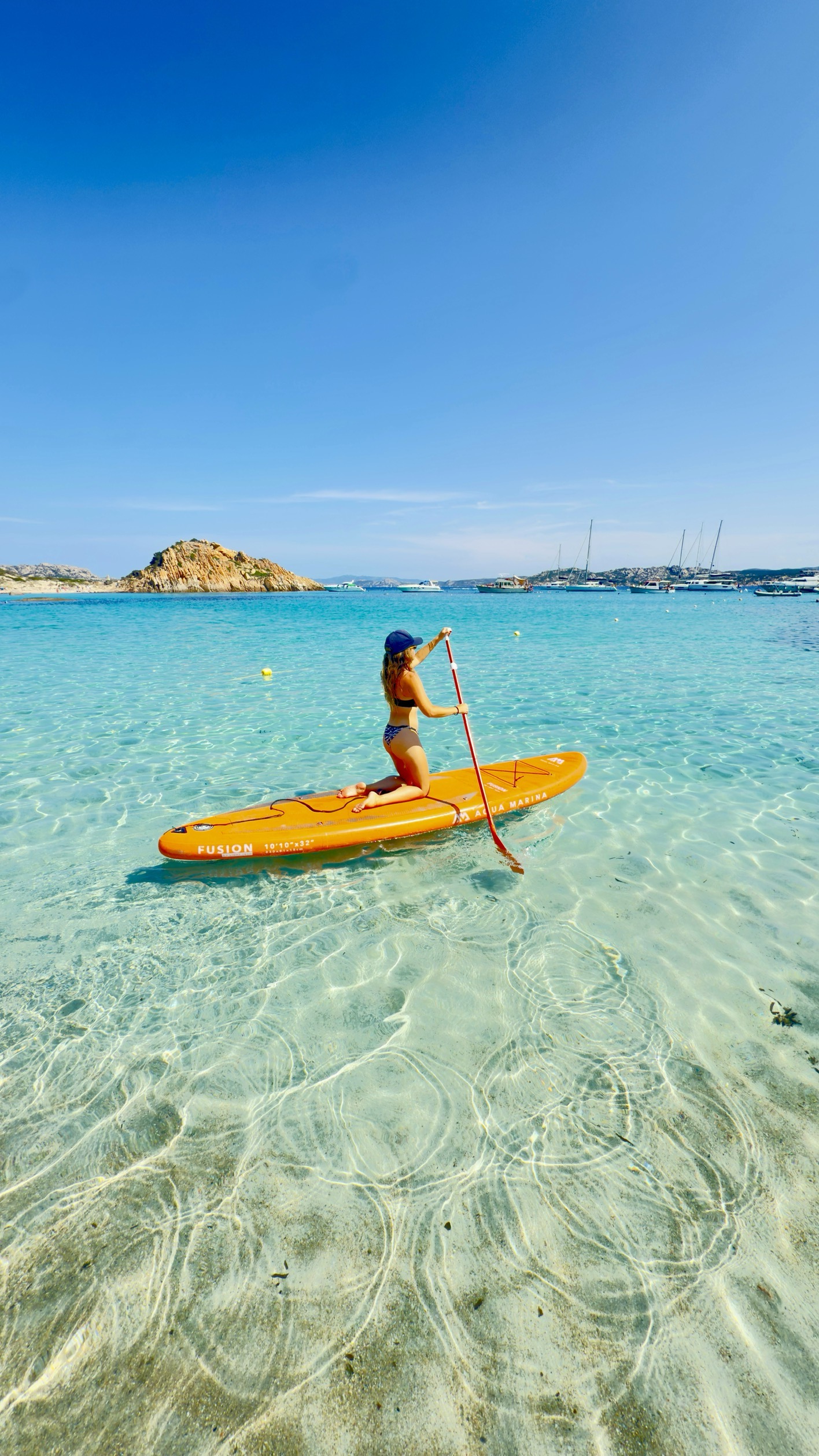 Guest paddleboarding on calm turquoise water near Espíritu Santo Island, Baja California Sur — BAIA Atelier